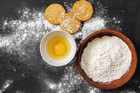 Preparation for baking. Eggs and flour on black backgroundの写真素材