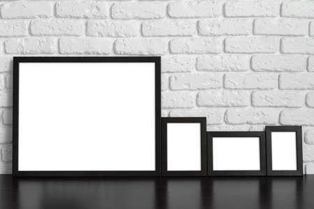 Blank picture frame against brick wall with copy spaceの写真素材