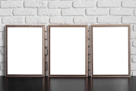 Blank picture frame against brick wall with copy spaceの写真素材