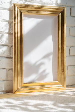 Photo frames on floor over white brick wallの写真素材