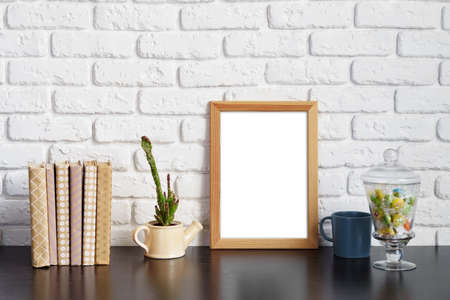 Books with picture frame on wooden tableの写真素材