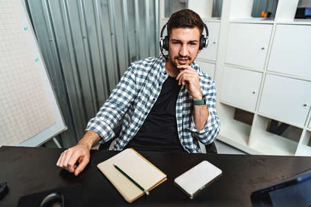 Customer service support operator man with headphones and microphone talking to client in call...
