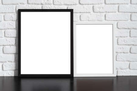 Blank picture frame against brick wall with copy spaceの写真素材