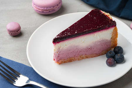 Piece of blueberry cheesecake on a white plateの写真素材