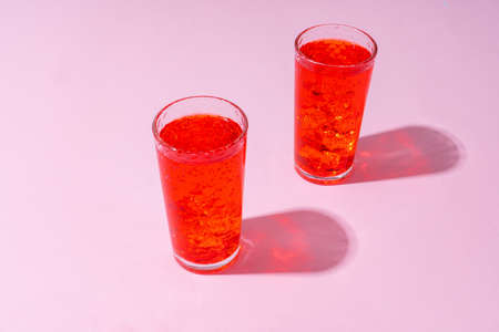 Refreshing pink punch cocktail on color backgroundの写真素材