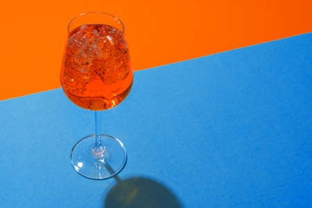 Glass of fresh cocktail on color backgroundの写真素材