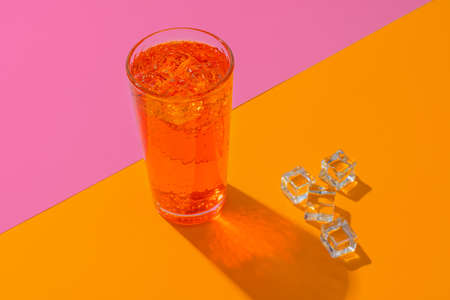 Glass of fresh cocktail on color backgroundの写真素材