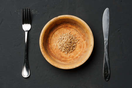Concept of a global food crisis caused by hunger due to lack of grain. Plate with small amount of...