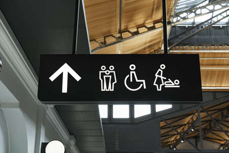 Modern public toilet sign on the wall