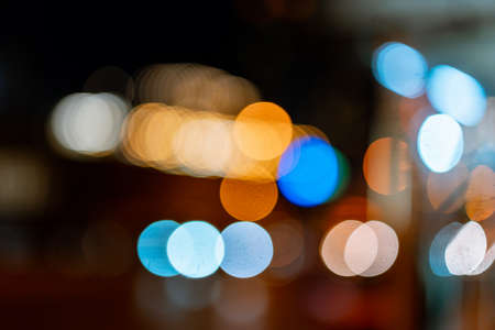 Bokeh traffic light at night in the street of a big city for backgroundの写真素材
