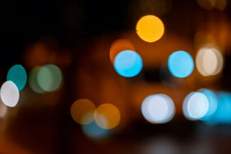 Bokeh traffic light at night in the street of a big city for backgroundの写真素材