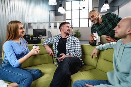 Young businesspeople talking during their office coffee breakの写真素材