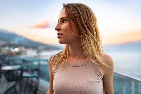 Portrait of a young beautiful woman in the summer city