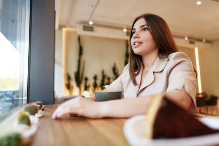 Young woman drinking coffee in a cafeの写真素材
