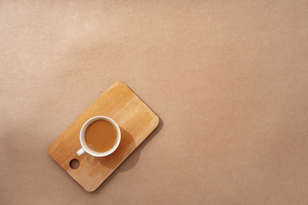 Top view of the wooden tray with coffee cup on beige backgroundの写真素材