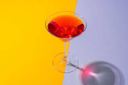 Glass of fresh cocktail on color backgroundの写真素材