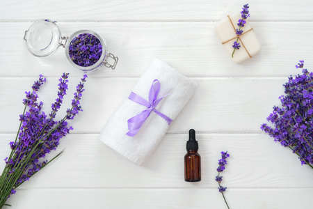 Lavender soap bars and spa products with lavender flowers on a white wooden tableの写真素材