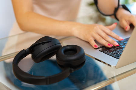 Close up of woman hands typing on laptop keyboard at the officeの写真素材