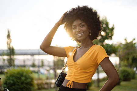 Portrait of a young african american woman smiling standing at the city.の写真素材