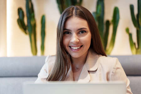 Young businesswoman using a laptop during a coffee break in coffeeshop