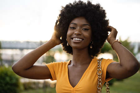 Portrait of a young african american woman smiling standing at the city.の写真素材