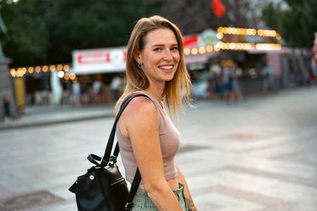 Portrait of a young beautiful woman in the summer city