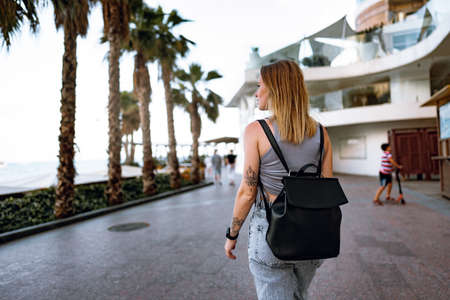 Beautiful casual young woman walking in the streetの写真素材