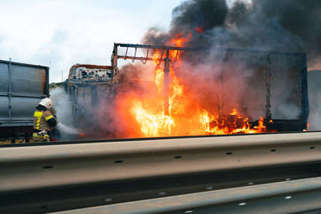 Car crash accident on a highway with damaged automobiles and smokeの写真素材