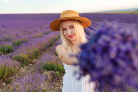 Blond haired girl standing in lavender fieldの写真素材