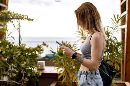 Young casual woman using her smartphone in the city.の写真素材