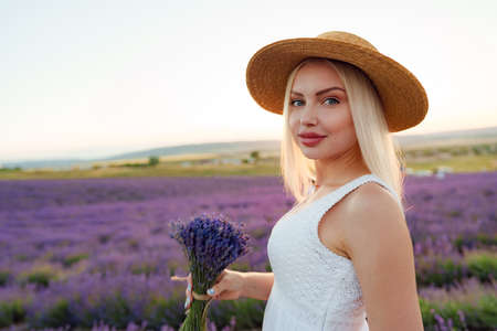 Blond haired girl standing in lavender fieldの写真素材