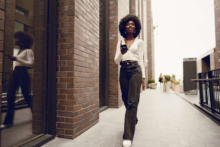 Portrait of attractive young woman walking outside in the cityの写真素材