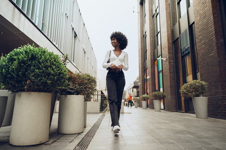 Portrait of attractive young woman walking outside in the cityの写真素材