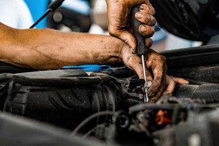 Close up of auto mechanic repairing car engine in car serviceの写真素材