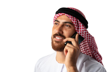Arab businessman talking on mobile phone isolated on white backgroundの写真素材