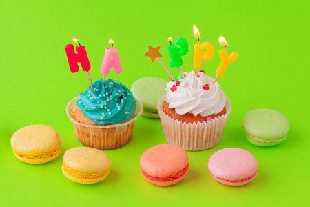 Delicious cupcakes with candles on a colored background. Festive background, birthdayの写真素材