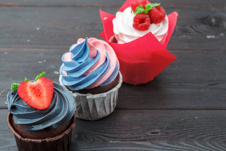 Set of different delicious cupcakes on darkの写真素材