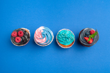 Birthday cupcakes on blue background close upの写真素材