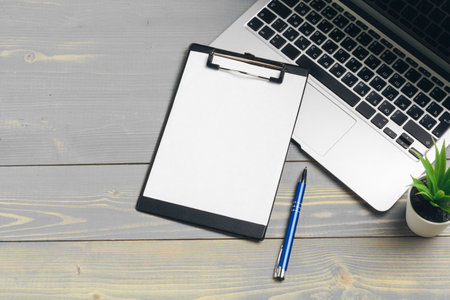 Clipboard with blank paper for copy space and supplies on wooden tableの写真素材