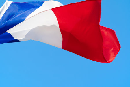 Flag of France waving in the wind in the skyの写真素材