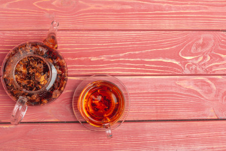 Kettle of herbal tea close up on wooden table top viewの写真素材