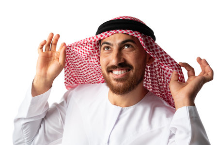 Portrait of smiling young Arab man on white backgroundの写真素材