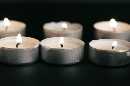 Candles Burning at Night. White Candles Burning in the Darkの写真素材