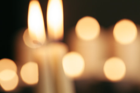 Burring candles on decorative glass. Dark background. Blurの写真素材