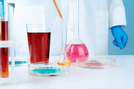 Manipulations with laboratory glass chemical containers on tableの写真素材