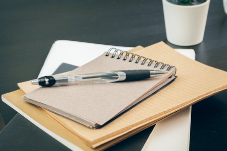 Pen and notebook up close on an office deskの写真素材
