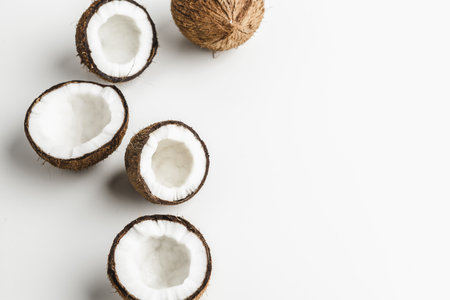 Ripe coconut pieces on white background, copy spaceの写真素材