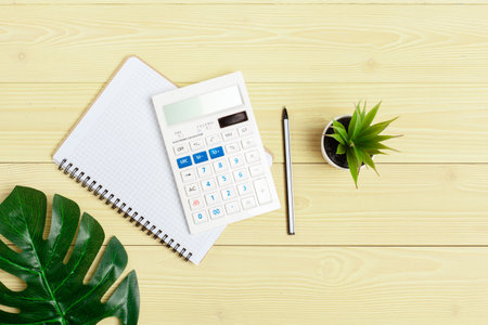 Office table with supplies and calculator close up