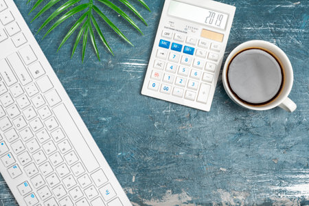 Office table with note paper, computer keyboard and supplies close up
