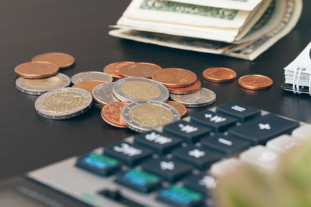 avings, finances, economy and home concept - close up of calculator counting money and making notes at homeの写真素材